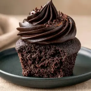 Close-up sliced view showing the open-crumb texture of moist vegan chocolate cupcakes. (vegan chocolate cupcakes)