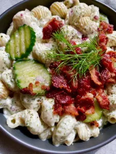Top-down macro shot of creamy rotini pasta salad with crinkle-cut pickles and fresh dill. (chococat coloring pages)